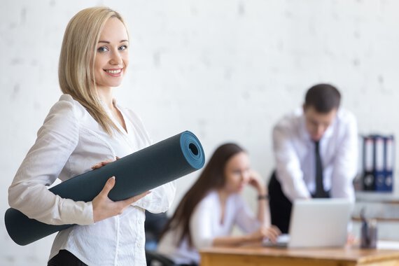 Employee with fitness mat