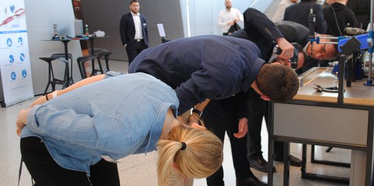 People watch attentively during a product presentation