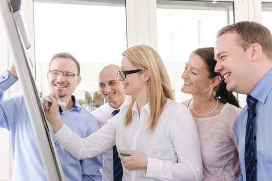Group photo of Böllhoff employees in front of a flip chart