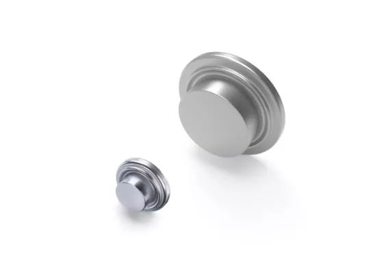 Two Böllhoff Weltac metal elements in different sizes, shown on a white background. The round fasteners feature the typical collar for secure closure of holes.