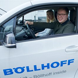 Photo of two Böllhoff apprentices in a company car