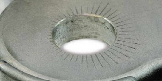 Detailní snímek hliníku s vrypy.