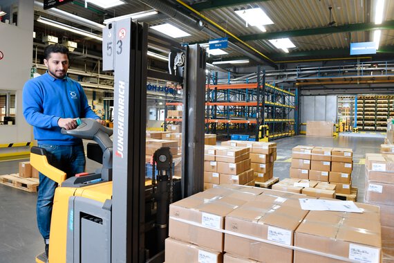 Photo of a Böllhoff apprentice on a loaded lift truck