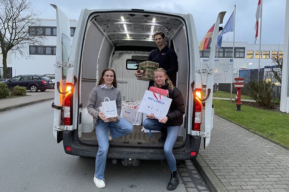 The donated gifts are handed over to employees of the German Red Cross by a Böllhoff employee.