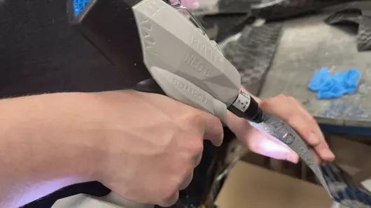 RIVKLE® NEO B109 battery-powered gun being used to assemble parts of a student formula car