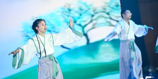 Two people perform a traditional dance at the Böllhoff 25th anniversary celebrations in China