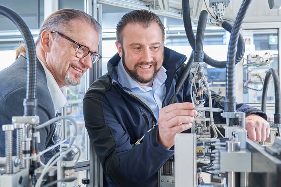 Two Böllhoff employees check a connection