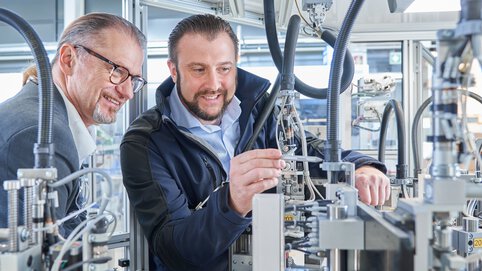 Two Böllhoff employees check a connection
