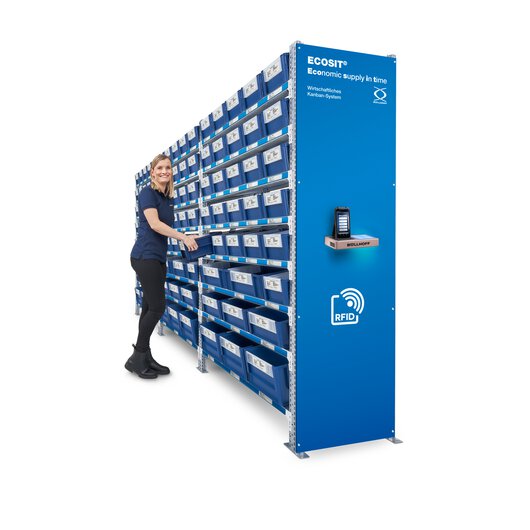 A woman standing at the control centre of an ECOSIT® system is reaching for a Kanban ECOBIN.