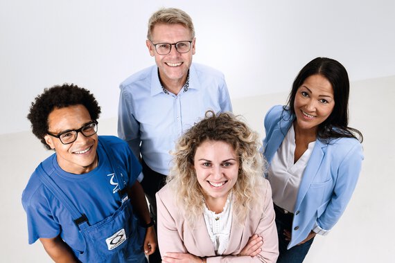 Four Böllhoff employees standing in a group looking at the camera