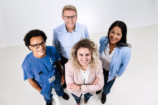 Four Böllhoff employees standing in a group looking at the camera