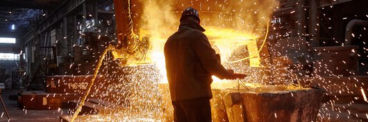 A steel worker producing steel at the steel furnace