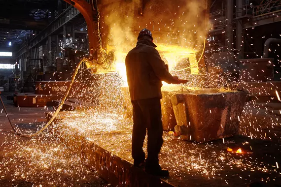 A steel worker producing steel at the steel furnace